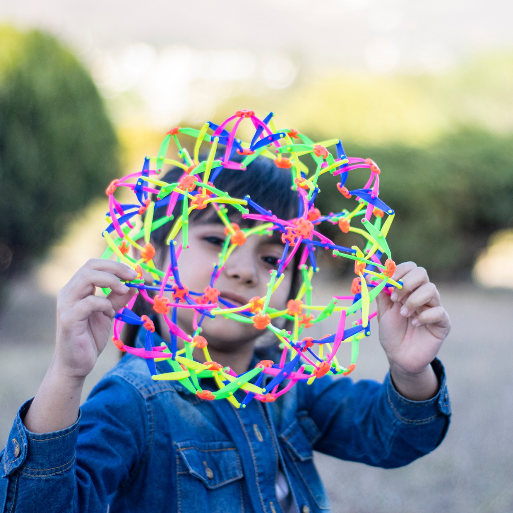 a child holding a colorful object