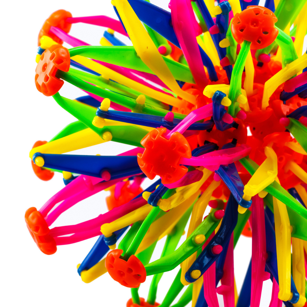 a close up of a ball of colorful plastic objects